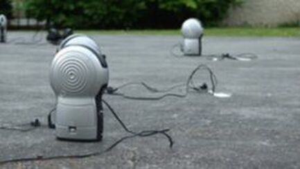 Sound art work - multiple radios spread across a floor outside in Whitstable