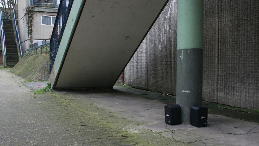 Sound installation - image of speakers against a building playing sound to the wall